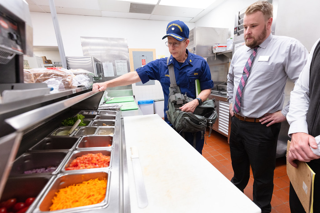 Commander George Larsen, Public Health Consultant, inspecting food services (2) — related to Fractional Chief Marketing Officer